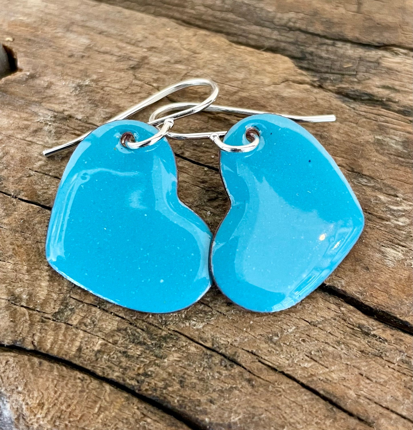 Turquoise enamel on copper hearts.